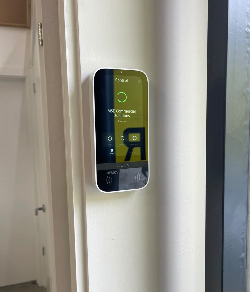 Ajax touchscreen keypad fitted on a wall at a business unit