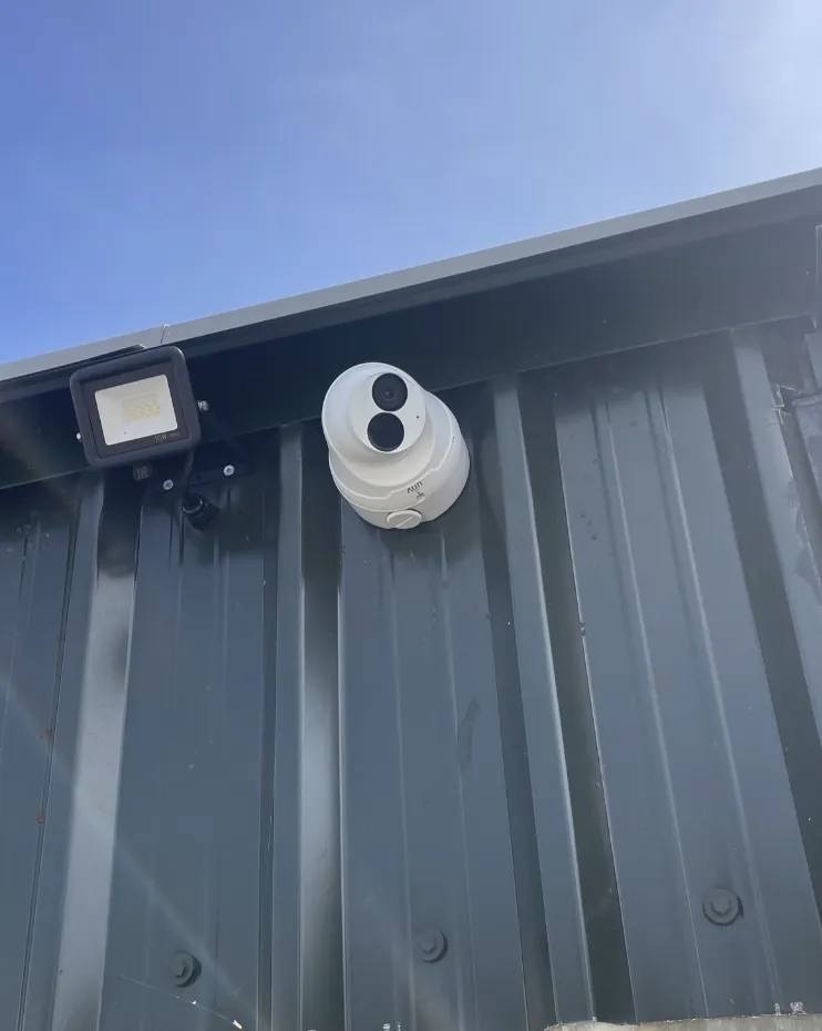 CCTV camera and floodlight on a steel clad unit
