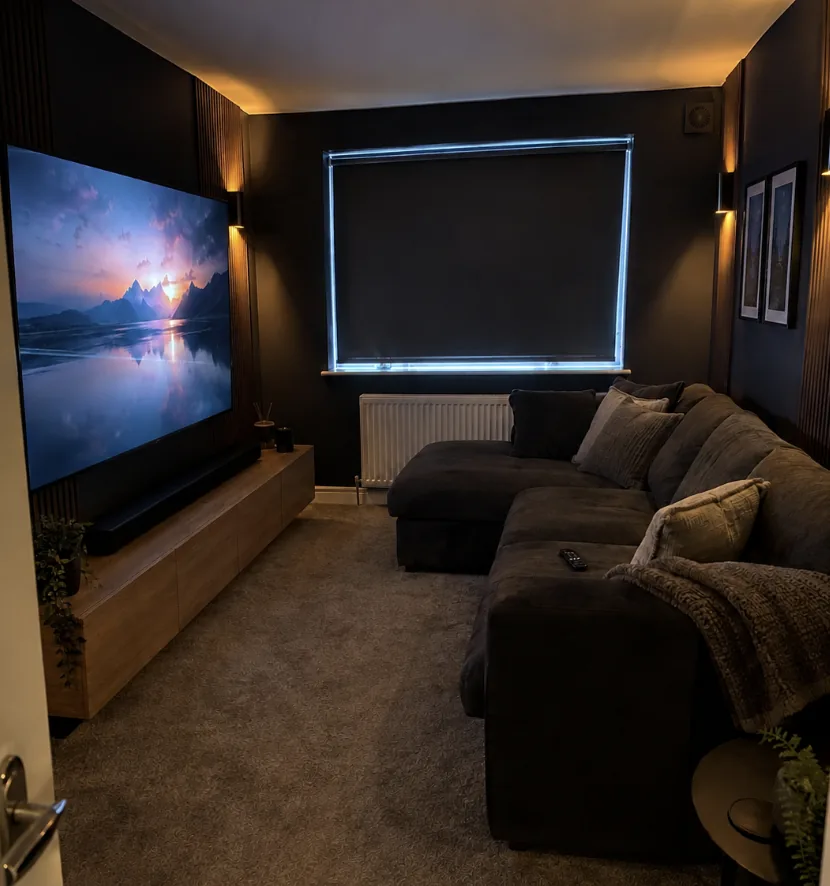 Cinema room with wall mounted TV and drop down projector screen