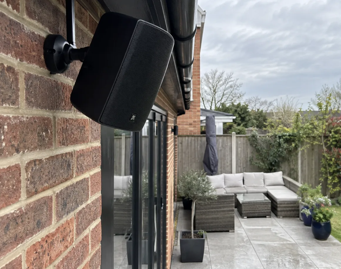 Outdoor speaker installed on a patio wall